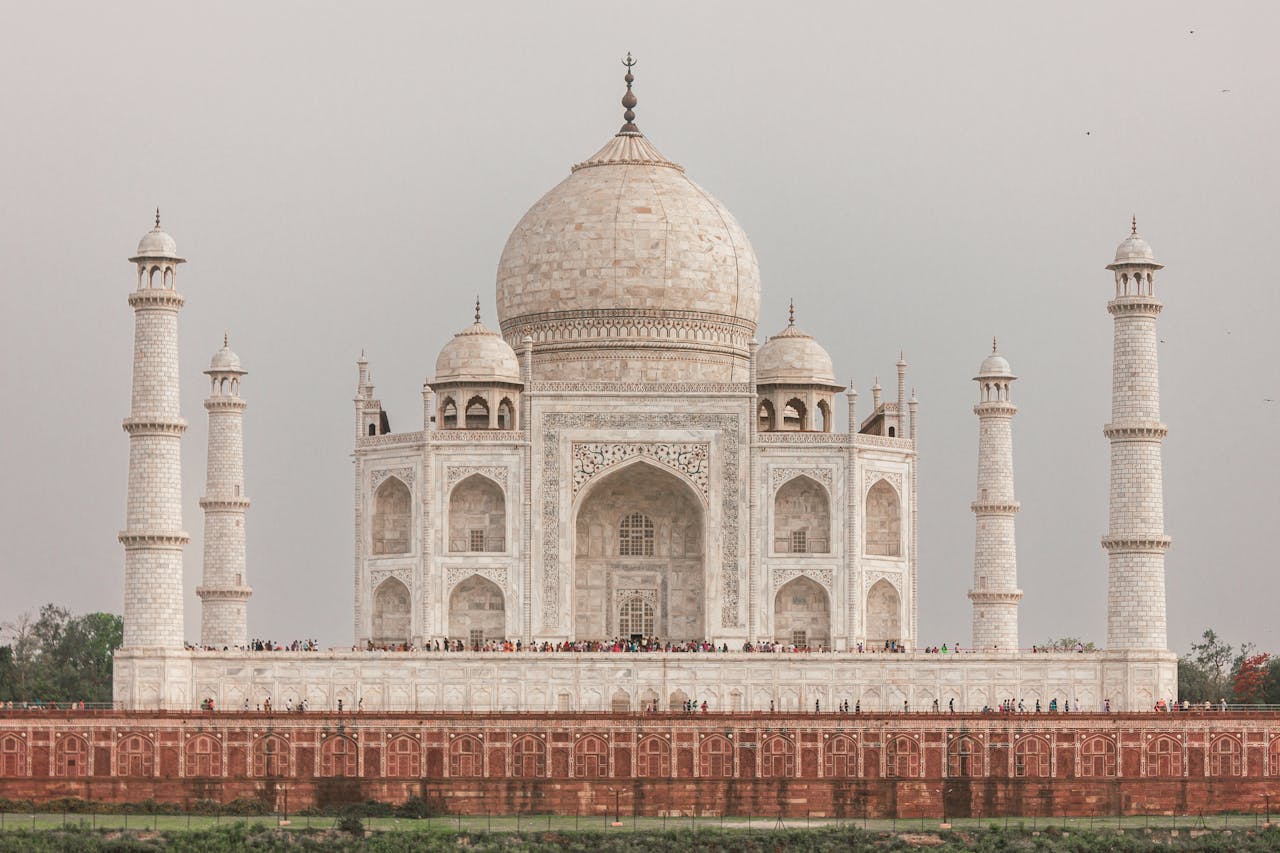 Iconic view of the Taj Mahal's grand facade and minarets in Agra, India.