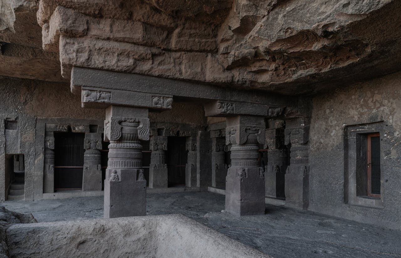 Explore the intricate stone carvings and pillars of the ancient Ellora Caves, Maharashtra, India.